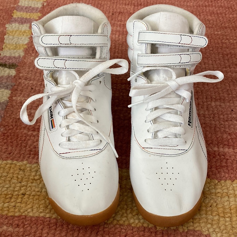 White Reebok classics with rainbow details